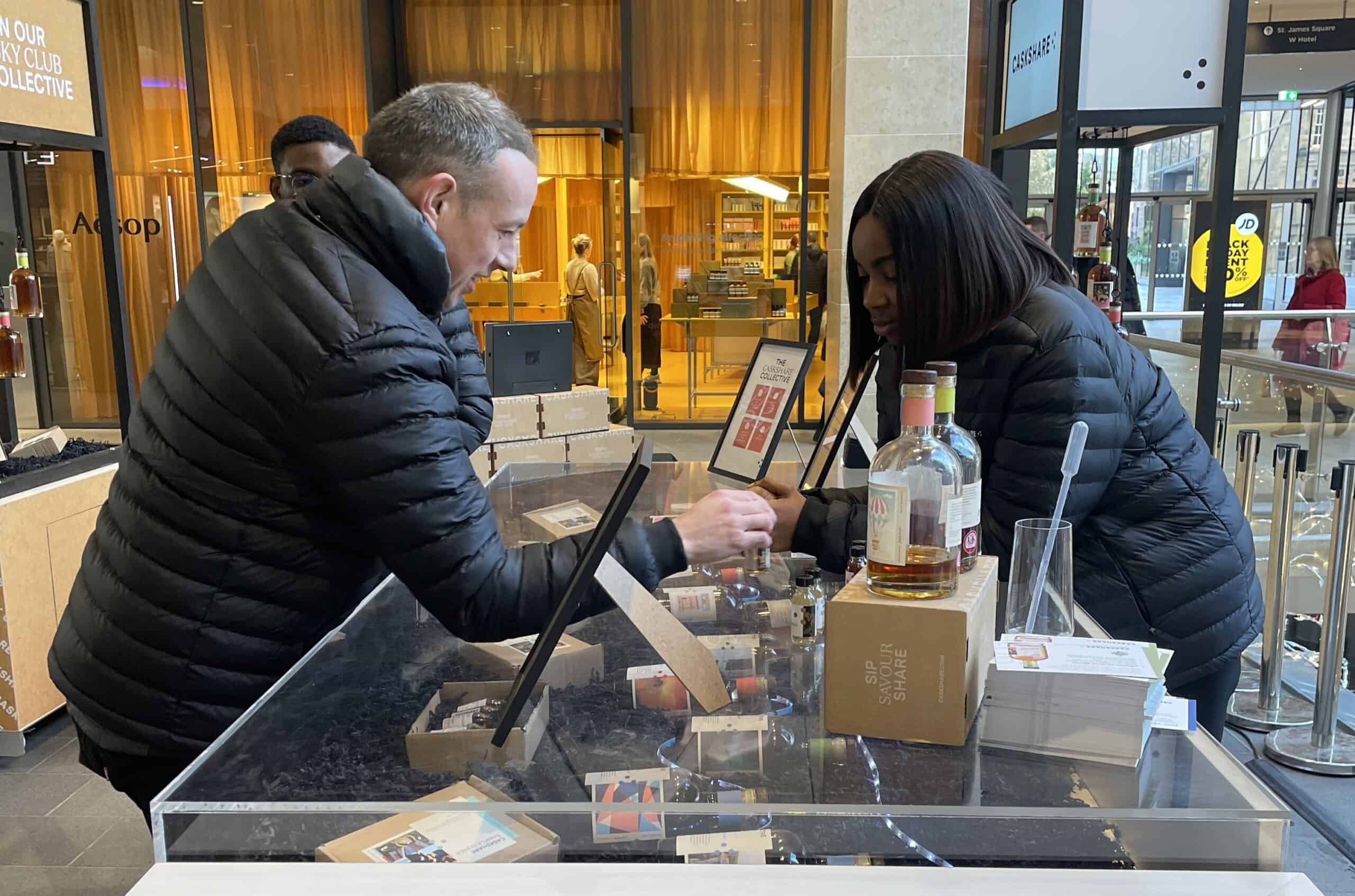 IMG_3787 edit brand ambassador working behind the whisky counter serving a customer