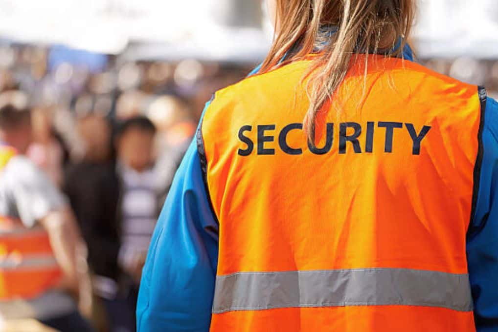 Untitled design Security steward in hi-vis with crowd