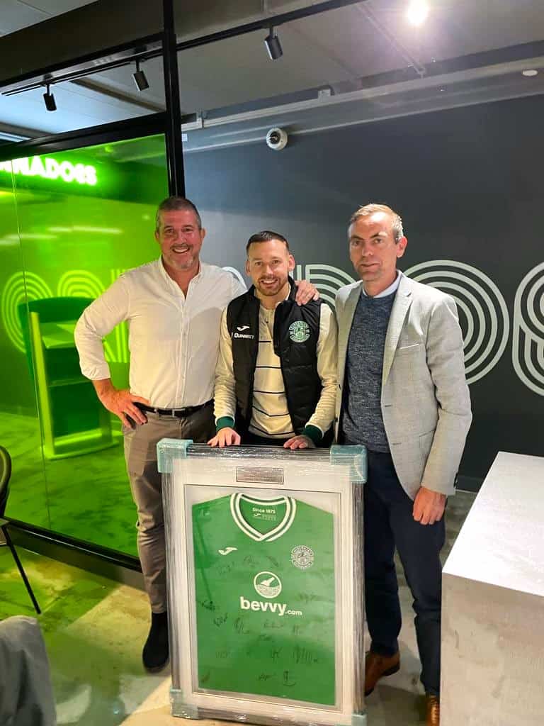 hibernian football team with signed shirt meeting sponsors
